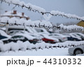 barbed wire fence on winter time backgruond white snow 44310332