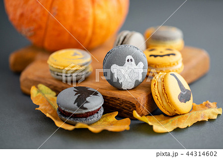 Halloween scary cookies with pumpkin on wooden cut board. pattern Bat , patina, ghosts and spiders 44314602