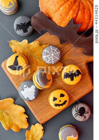 Halloween scary cookies with pumpkin on wooden cut board. pattern Bat , patina, ghosts and spiders 44314620