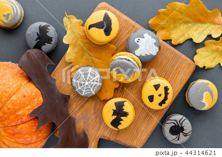 Halloween scary cookies with pumpkin on wooden cut board. pattern Bat , patina, ghosts and spiders 44314621