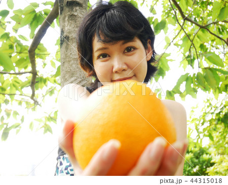 Beautiful girl teen holding orange fruit. Beautiful girl teen holding orange fruit. 44315018