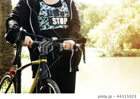 Beautiful girl teen walking and bicycle in park. 44315023