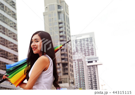 Beautiful women holding umbrella on the street. 44315115