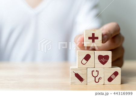 Hand arranging wood block stacking with icon 44316999