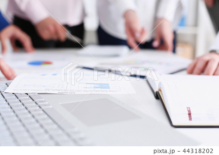 Important paper lie at table with group of colleagues Important paper lie at table with group of colleagues 44318202