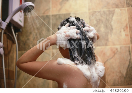Beautiful young woman using shampoo taking bath. Beautiful young woman using shampoo taking bath. 44320100