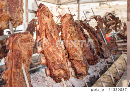Roasted meat of beef cooking. Asado Argentina Roasted meat of beef cooking. Asado Argentina 44320887