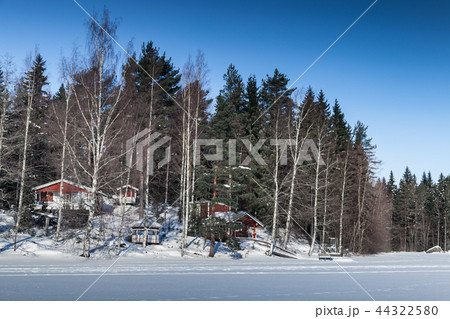 Rural winter landscape with red houses 44322580