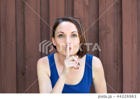 young girl posing on red brown wooden background 44326963