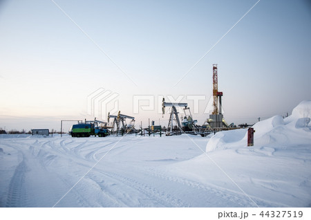 Oil field. Drilling rig and oil pump. Oil field. Drilling rig and oil pump. 44327519