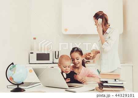 Young Girl Plays With Baby Brother On Kitchen. 44329101