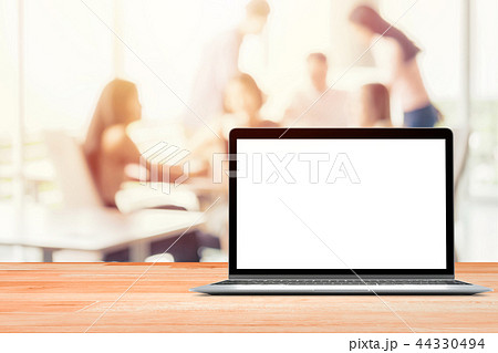 Laptop with blank screen placed on wooden table Blurred people meeting background ,Startup Business 44330494