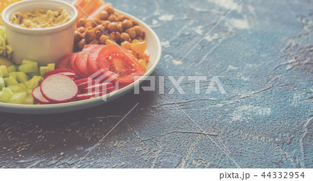 Healthy cut vegetables on the blue table Healthy cut vegetables on the blue table 44332954