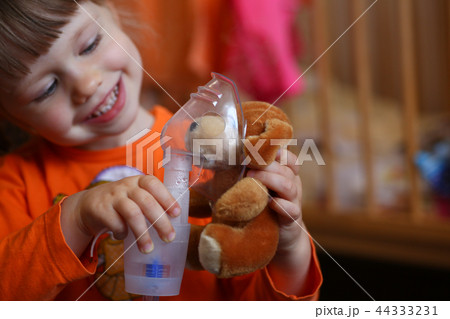 Happy child makes inhalation at home for 44333231