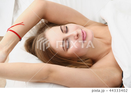 Young beautiful woman waking up in the morning Young beautiful woman waking up in the morning 44333402