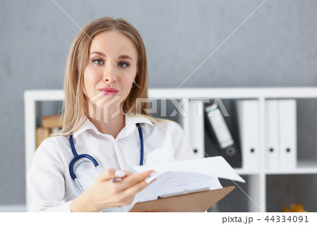 Beautiful smiling female doctor stand in office portrait Beautiful smiling female doctor stand in office portrait 44334091