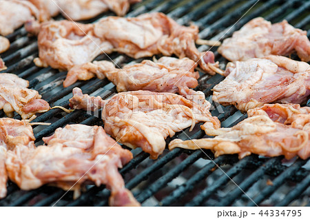 Chicken thighs and legs at barbeque grate Chicken thighs and legs at barbeque grate 44334795