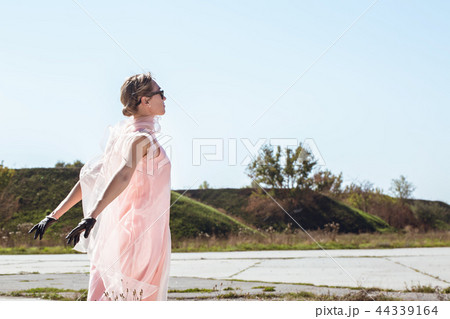 Woman in short, black gloves Woman in short, black gloves 44339164