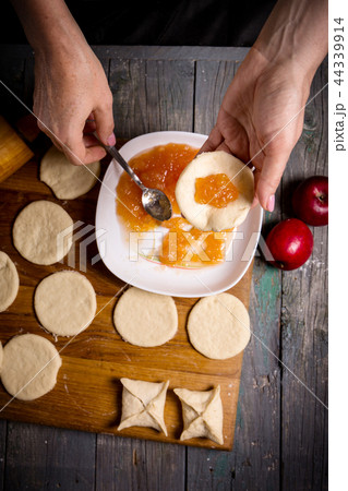 woman making pies with apple jam woman making pies with apple jam 44339914