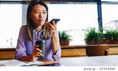 Young businesswoman sitting at cafe  44341806