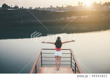 young girl enjoying sunset on the balcony 44341822