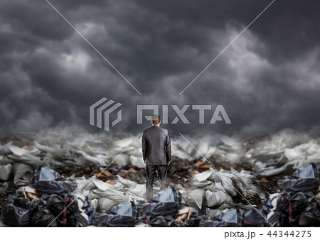 Businessman in the middle of garbage, back view Businessman in the middle of garbage, back view 44344275