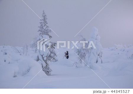 Woman Photographer Shoots a Winter Landscape Woman Photographer Shoots a Winter Landscape 44345527