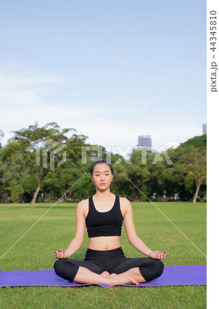 Woman Doing Meditation In Park Woman Doing Meditation In Park 44345810