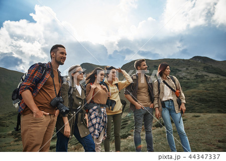Confident hikers carrying backpacks and looking ready for trip Confident hikers carrying backpacks and looking ready for trip 44347337