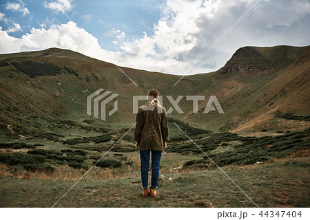 Peaceful woman standing alone and looking at the landscape 44347404