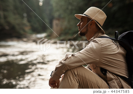 Bearded man frowning and looking into the distance Bearded man frowning and looking into the distance 44347585