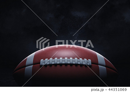 3d rendering of a leather ball for American football lying with its seams in focus on a dark 44351069