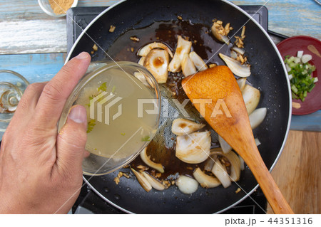 Chef poring soup for cooking 44351316