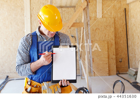 Worker pointing at clipboard 44351630