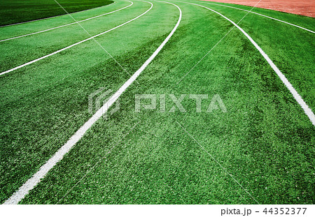 Running track with bright green artificial turf Running track with bright green artificial turf 44352377