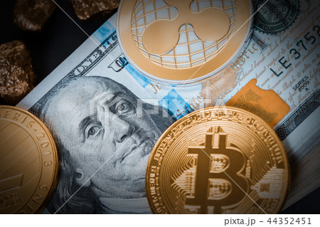 cryptocurrency and hundred dollar bills 44352451