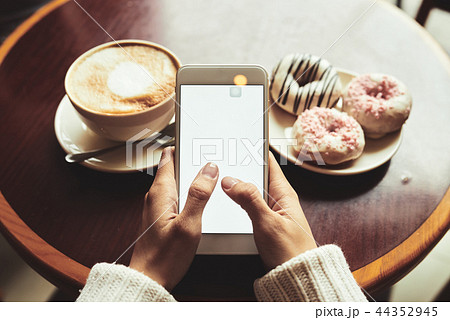 Enjoying coffee and texting Enjoying coffee and texting 44352945