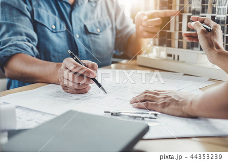 Hands of architect or engineer working on blueprint meeting for 44353239