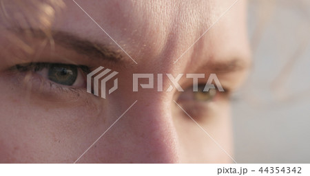 young female closeup portrait sitting on a seashore with thoughtful look young female closeup portrait sitting on a seashore with thoughtful look 44354342