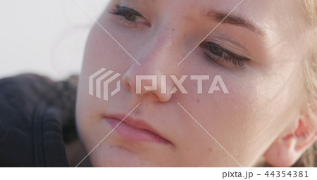 young female closeup portrait sitting on a seashore with thoughtful look young female closeup portrait sitting on a seashore with thoughtful look 44354381