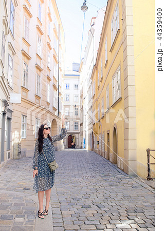 Woman walking in city. Young attractive tourist outdoors in european city Woman walking in city. Young attractive tourist outdoors in european city 44359409