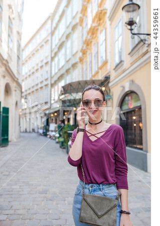 Woman talk by her smartphone in city. Young attractive tourist outdoors in italian city 44359661