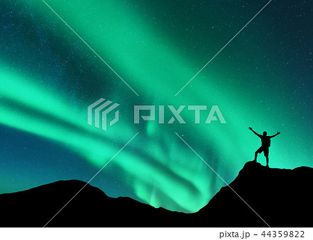 Northern lights and happy man. Aurora 44359822