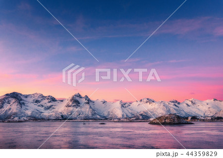 Mountains and colorful sky reflected in water 44359829