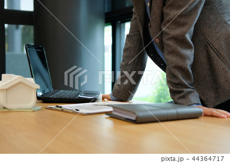 real estate agent realtor with house model computer & contract agreement. buying selling renting property 44364717