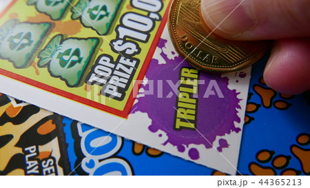 Woman scratching lottery ticket. Woman scratching lottery ticket. 44365213
