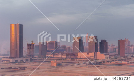 Buildings on Al Reem island in Abu Dhabi night to day timelapse from above. Buildings on Al Reem island in Abu Dhabi night to day timelapse from above. 44365734