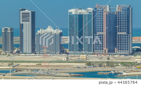 Buildings on Al Reem island in Abu Dhabi timelapse from above. 44365764