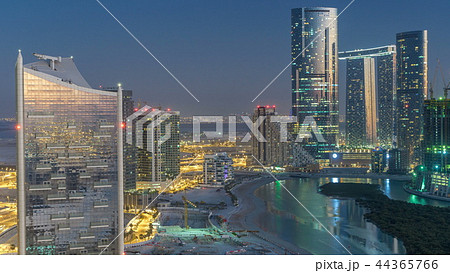 Buildings on Al Reem island in Abu Dhabi day to night timelapse from above. 44365766