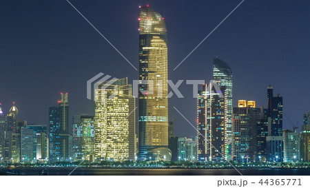 Panorama view of Abu Dhabi Skyline and seafront at night timelapse, United Arab Emirates 44365771